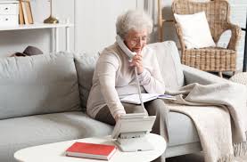 Senior woman relaxing at home on the phone